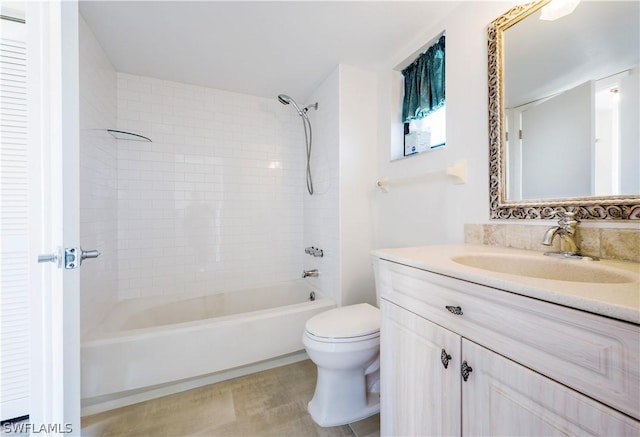 full bathroom with vanity, tiled shower / bath combo, and toilet