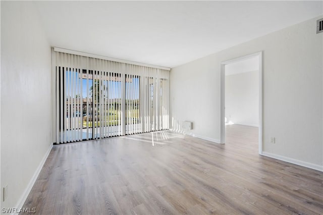 unfurnished room with light wood-type flooring