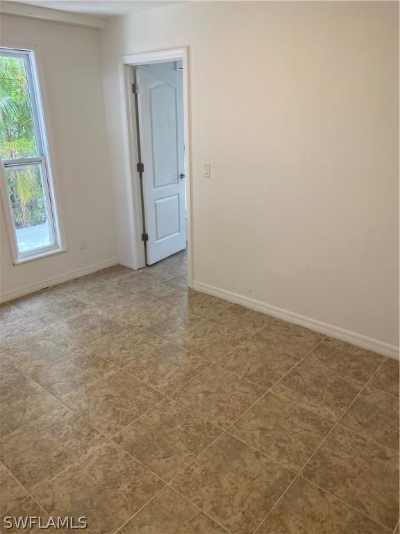 tiled empty room with baseboards