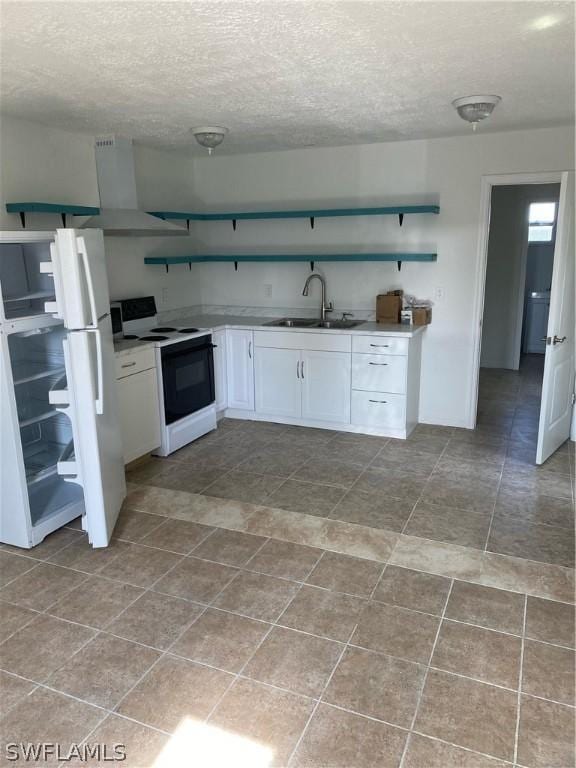 kitchen featuring a sink, range with electric cooktop, freestanding refrigerator, white cabinetry, and open shelves