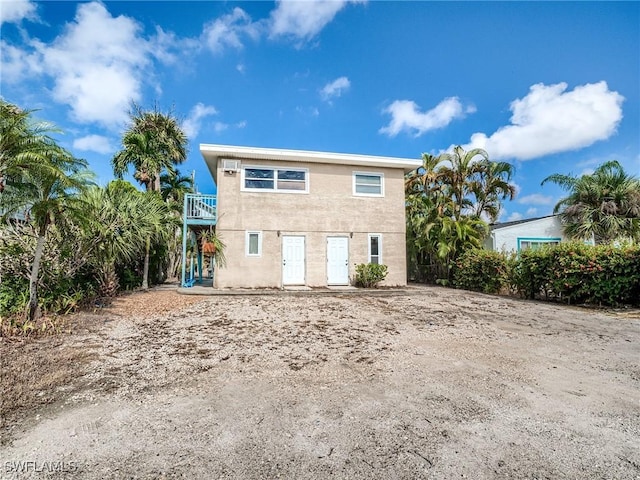 back of property featuring stucco siding and a balcony