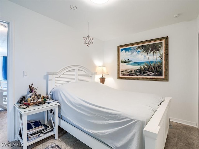 bedroom with tile patterned flooring and baseboards