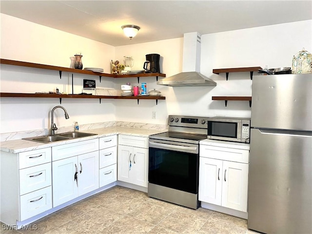 kitchen featuring open shelves, light countertops, appliances with stainless steel finishes, wall chimney exhaust hood, and a sink