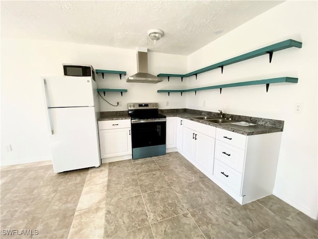 kitchen featuring open shelves, a sink, stainless steel range with electric cooktop, freestanding refrigerator, and wall chimney exhaust hood