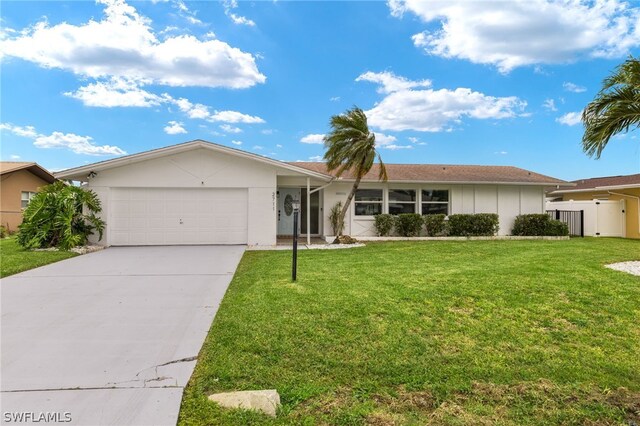 ranch-style house featuring a garage and a front lawn