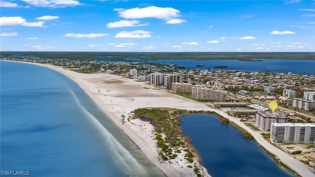 birds eye view of property featuring a view of the beach and a water view