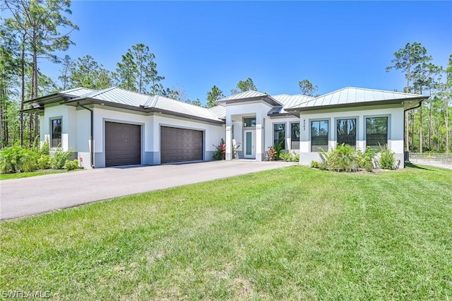 view of front of property featuring a garage and a front yard