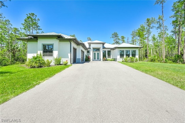 view of front of property featuring french doors and a front lawn