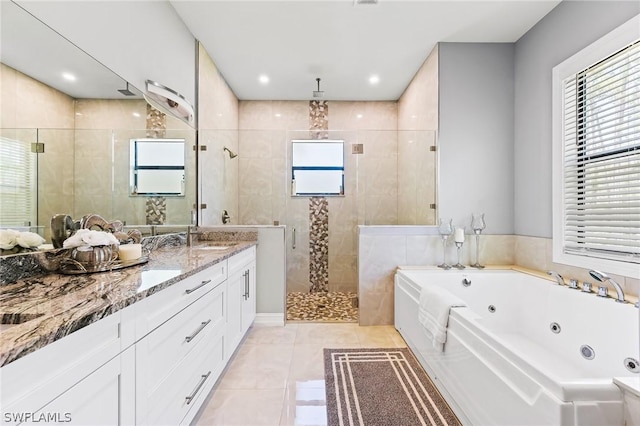 bathroom with tile patterned flooring, vanity, and separate shower and tub