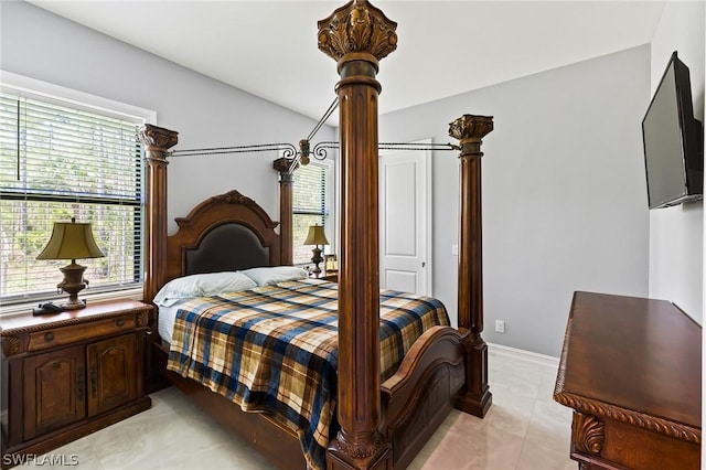 bedroom with light tile patterned flooring and lofted ceiling