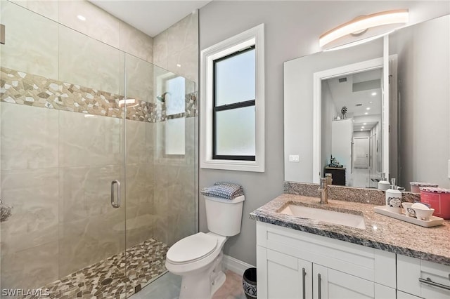 bathroom with vanity, toilet, and walk in shower