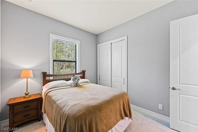 bedroom featuring light tile patterned floors and a closet