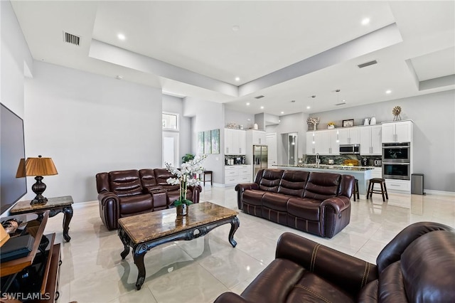 living room featuring a raised ceiling