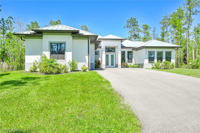 view of front of property with a front yard and french doors