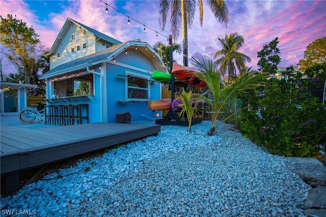 exterior space with a wooden deck and exterior bar