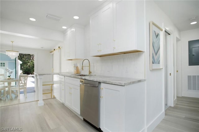 kitchen featuring light stone counters, sink, white cabinets, and dishwasher