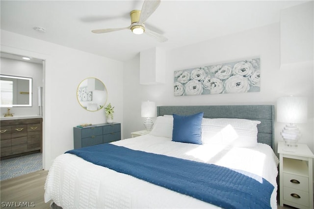 bedroom featuring ceiling fan, hardwood / wood-style floors, and ensuite bath