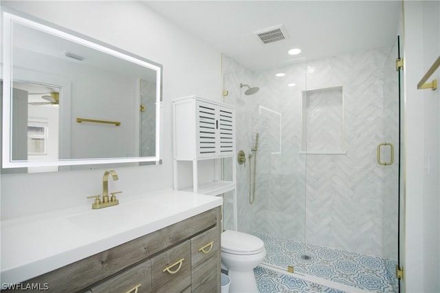 bathroom with toilet, vanity, and walk in shower