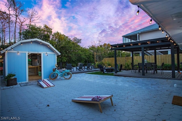 exterior space featuring a wooden deck and a shed