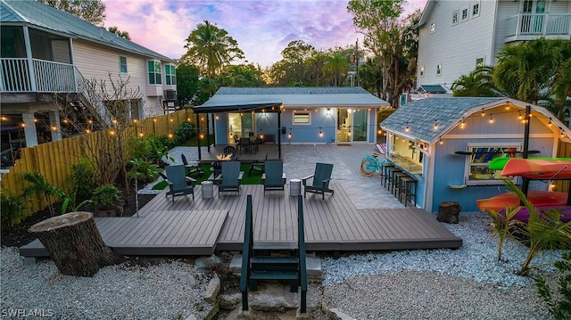 deck at dusk with a bar