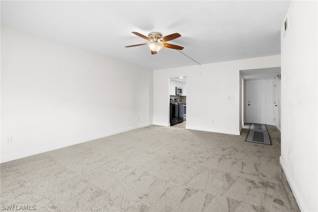 unfurnished living room featuring ceiling fan and light colored carpet