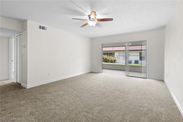 empty room featuring carpet floors and ceiling fan