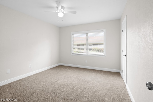 empty room featuring carpet floors and ceiling fan