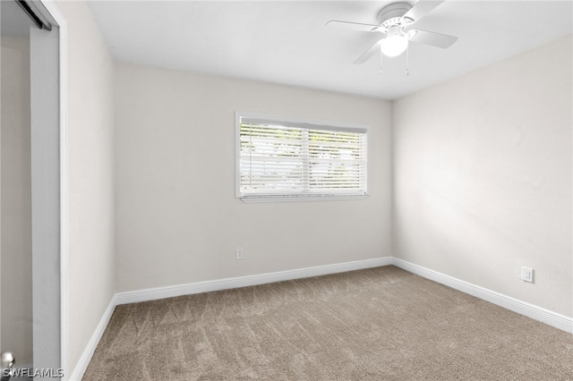 carpeted empty room with ceiling fan