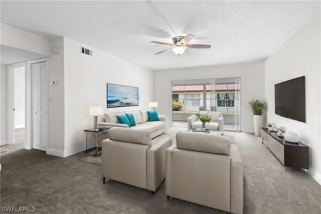 carpeted living room with ceiling fan