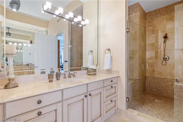 bathroom featuring vanity, a shower with shower door, and tile patterned floors