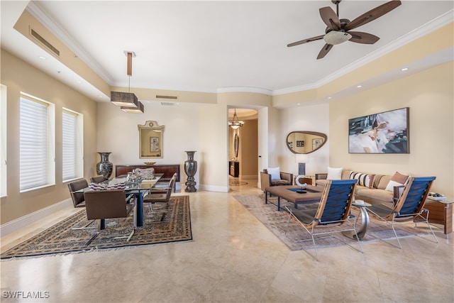 interior space with ornamental molding and ceiling fan