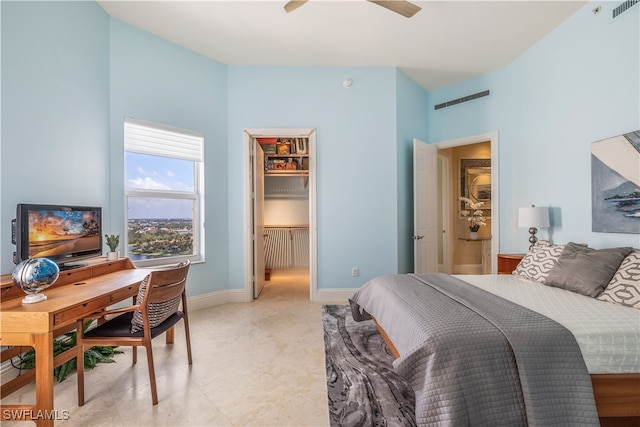 bedroom featuring a spacious closet, ceiling fan, and a closet