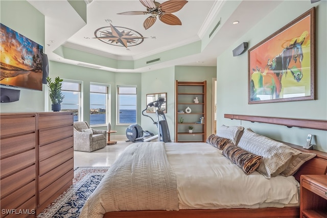 bedroom with crown molding, a water view, ceiling fan, and a tray ceiling