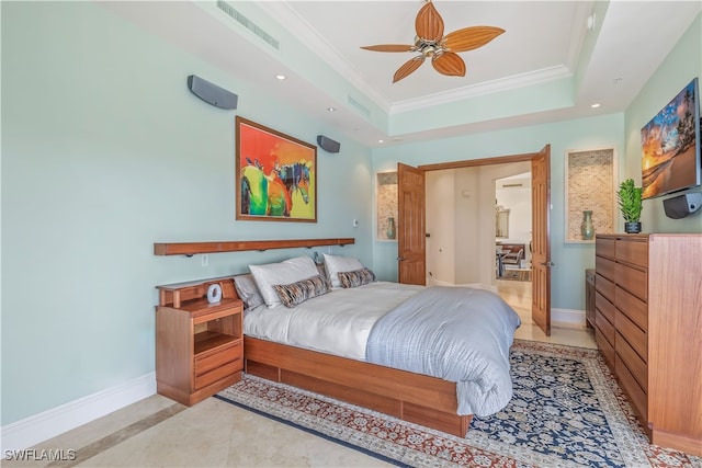 tiled bedroom with ornamental molding, a raised ceiling, and ceiling fan