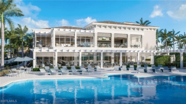 back of house with a patio area, a balcony, and a community pool