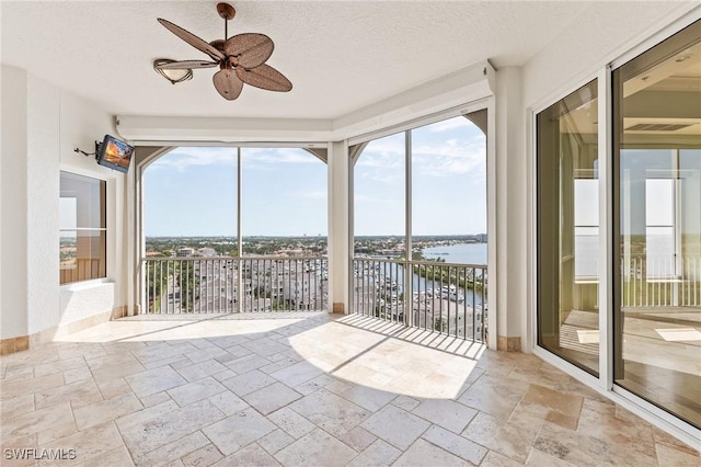 14270 Royal Harbour Ct Unit 1122, Fort Myers, FL 33908 - unfurnished sunroom with a water view, stone tile floors, and a textured ceiling