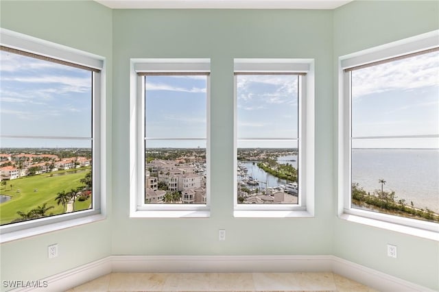 14270 Royal Harbour Ct Unit 1122, Fort Myers, FL 33908 - tiled empty room with a water view and baseboards