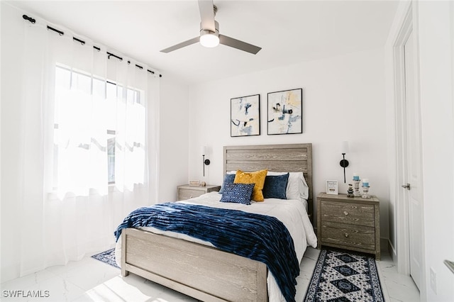 tiled bedroom with multiple windows and ceiling fan