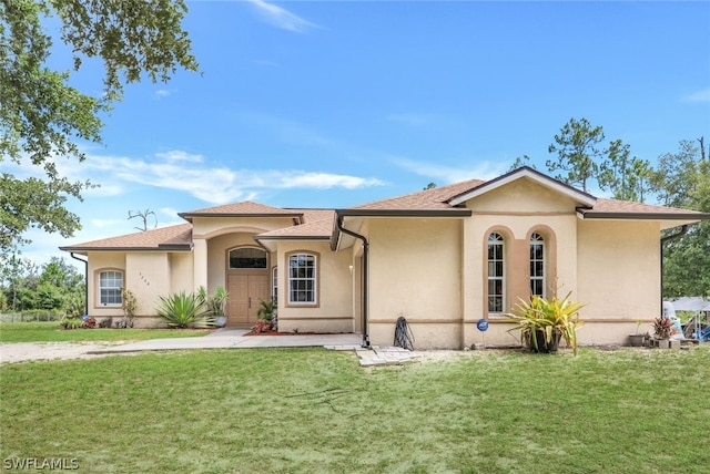 mediterranean / spanish house with a front yard