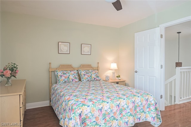 bedroom with wood finished floors, a ceiling fan, and baseboards