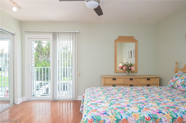 bedroom with a ceiling fan, access to outside, baseboards, and wood finished floors