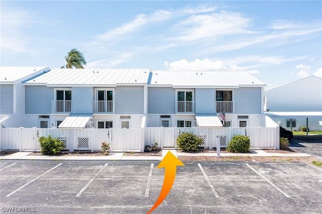 exterior space featuring uncovered parking and fence