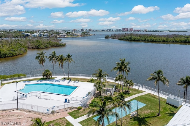 pool featuring a view of city, a water view, and fence