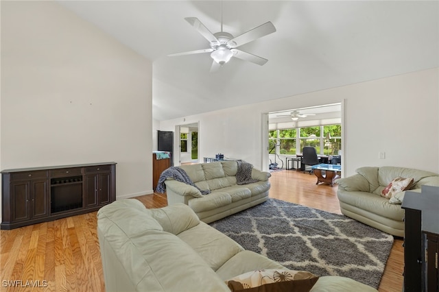 living room with light hardwood / wood-style floors, high vaulted ceiling, and ceiling fan