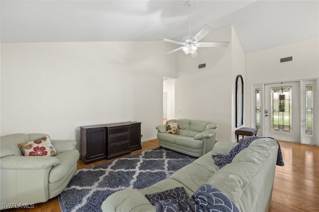 living room featuring high vaulted ceiling, ceiling fan, and wood-type flooring