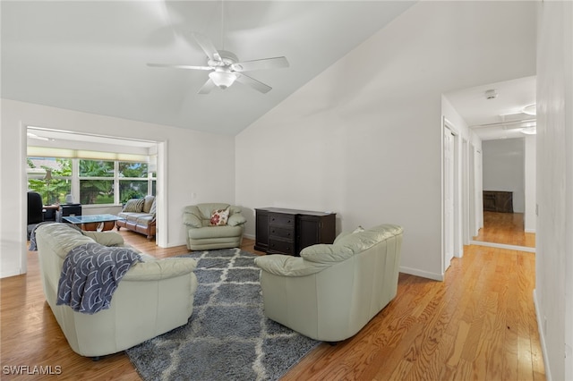 living room featuring high vaulted ceiling, light wood-type flooring, and ceiling fan