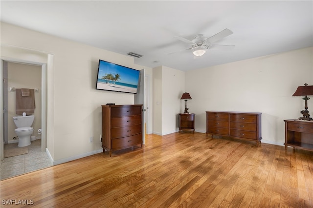 unfurnished bedroom featuring ensuite bathroom, light wood-type flooring, and ceiling fan