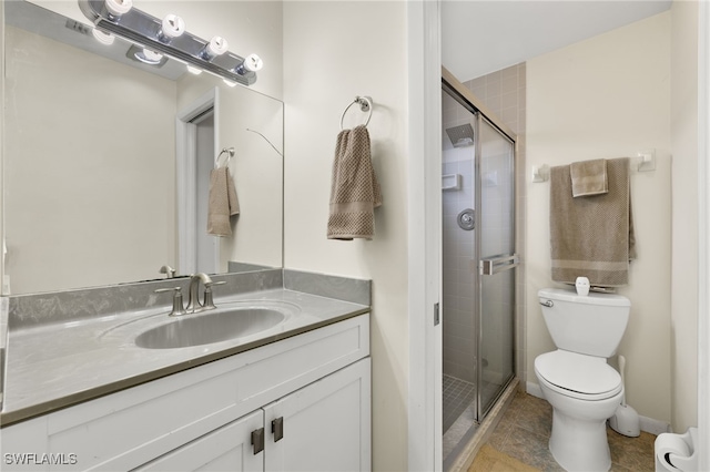 bathroom with an enclosed shower, vanity, tile patterned floors, and toilet