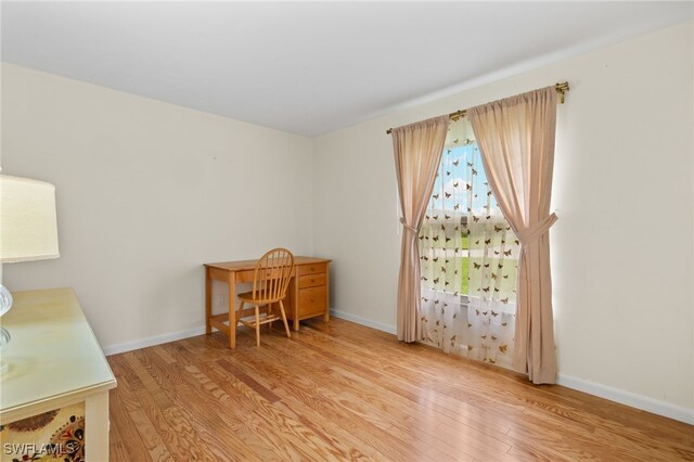 office with light hardwood / wood-style floors