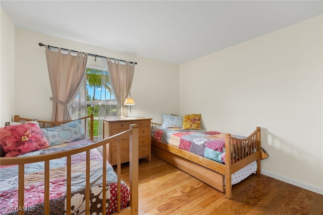 bedroom with hardwood / wood-style floors